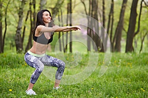 Beautiful woman working out in summer park