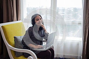 A beautiful woman is working on a task on the laptop