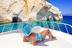 Beautiful woman on yacht cruise at the blue caves of Zakynthos island. Greece photo