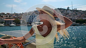 Beautiful woman on a yacht enjoys the journey, Poros, Greece, Europe