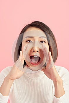 Beautiful woman yelling happily isolated on a white background