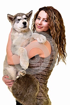 Beautiful woman with young dog Malamute