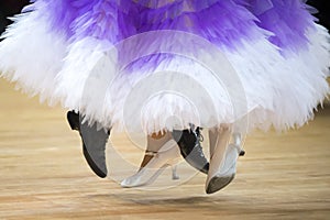 Beautiful womanish and masculine legs in active ballroom dance, photo