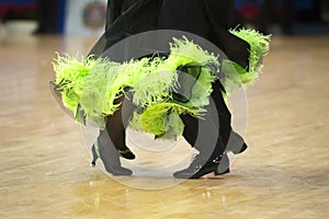 Beautiful womanish and masculine legs in active ballroom dance,