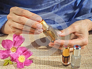 Beautiful womans hands holding a small vial of scented oil. Arab Attar.