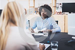 Beautiful womans making business meeting in modern office. Group of girls coworkers discussing together new fashion project.