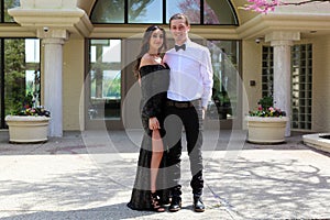 Beautiful woman in back prom dress and handsome guy in suit, teenager ready for a luxury night.