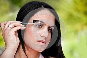 Beautiful women combing eye brows