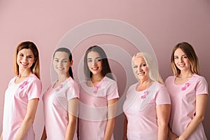 Beautiful women of different ages with pink ribbons on color background. Breast cancer concept