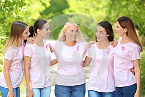 Beautiful women of different ages with pink ribbons outdoors. Breast cancer concept