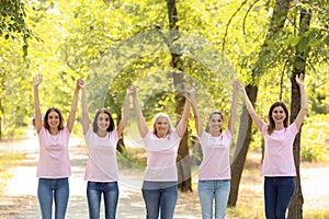 Beautiful women of different ages with pink ribbons outdoors. Breast cancer concept