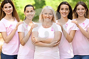 Beautiful women of different ages with pink ribbons outdoors. Breast cancer concept