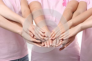 Beautiful women of different ages putting hands together, closeup. Breast cancer concept