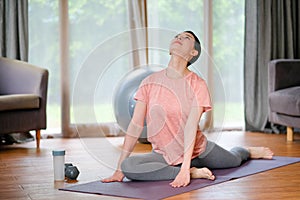 Beautiful women doing yoga with different posture and she look happy and relax in living room. Concept of workout at home for good