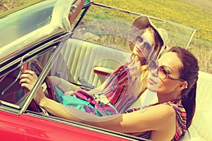 Beautiful women driving a red car retro vintage wearing accesoriess