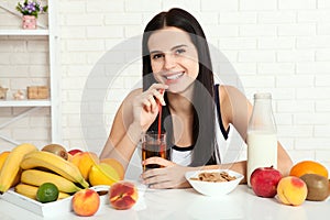 Beautiful women exists with pure skin on her face sitting at a table and eat breakfast. Asian woman eating healthy food at