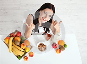 Beautiful women exists with pure skin on her face sitting at a table and eat breakfast. Asian woman eating healthy food at