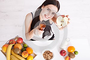 Beautiful women exists with pure skin on her face sitting at a table and eat breakfast. Asian woman eating healthy food at