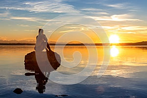 Beautiful women girl are sitting on a stone