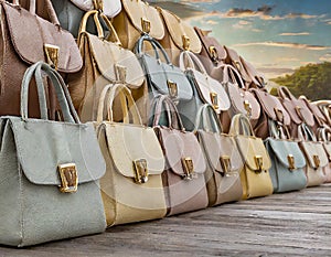 Beautiful women leather bags in varying pastel colors in a row