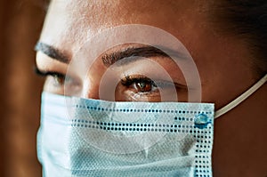 Beautiful Women In A Medical Mask. Close-up of a young girl with a surgical mask on her face against SARS-cov-2