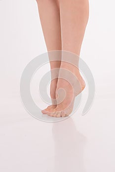 beautiful women& x27;s feet on white background. Pure white skin of the feet, shaving the legs with a razor, varicose