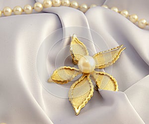 Beautiful women`s vintage gold brooch, with bright natural pearls