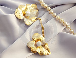 Beautiful women`s vintage gold brooch, with bright natural pearls