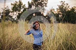 Beautiful women taking pictures in the grass fields