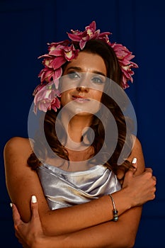 Beautiful women under white veil and red flowers on her head and big eyes