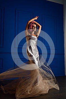 Beautiful women under white veil and red flowers on her head and big eyes