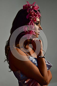 Beautiful women under white veil and red flowers on her head and big eyes