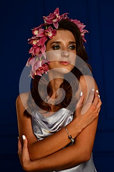 Beautiful women under white veil and red flowers on her head and big eyes