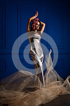 Beautiful women under white veil and red flowers on her head and big eyes