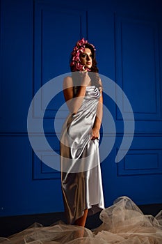 Beautiful women under white veil and red flowers on her head and big eyes