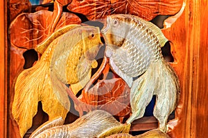 Beautiful Wood carving of gold silver fishes. Antique Art Handmade Furniture which Carvings gold silver fishes in The Wood. Gold