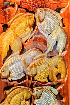 Beautiful Wood carving of gold silver fishes. Antique Art Handmade Furniture which Carvings gold silver fishes in The Wood. Gold