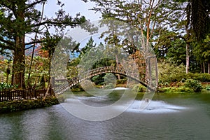 Beautiful wooden arch bridge scenics at University pond in Xitou Nature Education Area photo