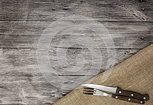 Beautiful wooden background with napkin knife and fork. Fine background for the menu of restaurants and cafes photo