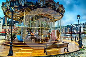 Beautiful wooden colorful French Carousel in Honfleur, Normandy, France, Europe