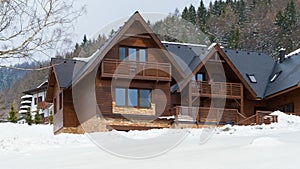 Beautiful wooden cottage covered in snow, ski resort Donovaly