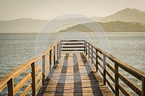 Beautiful wooden dock in pond overlooking mountains, quiet view