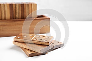 Beautiful wooden dominoes tiles on white table