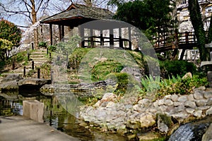 Beautiful wooden gazebo in the spring park near the pond. Japanese Garden in Botanical Garden Jevremovac , Belgrade-