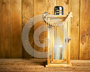 Beautiful wooden lantern on background of old wooden boards