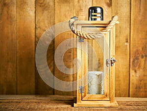 Beautiful wooden lantern on background of old wooden boards