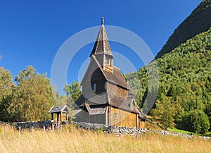 Beautiful Wooden Stave Church Of Urnes Surrounded By Mountains And Trees At Lustrafjord