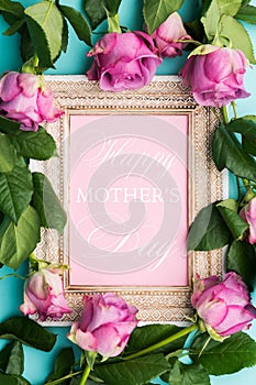 Beautiful wooden vintage picture frame with Happy Mothers Day wish and fresh pink roses.