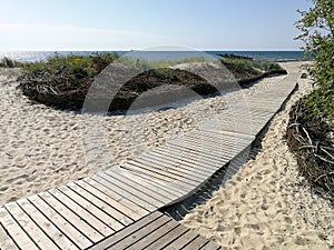 Beautiful wooden way through the sandy dunes in Sventoji town