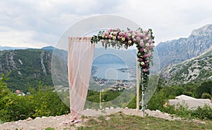 Beautiful wooden wedding arch decorated with flowers